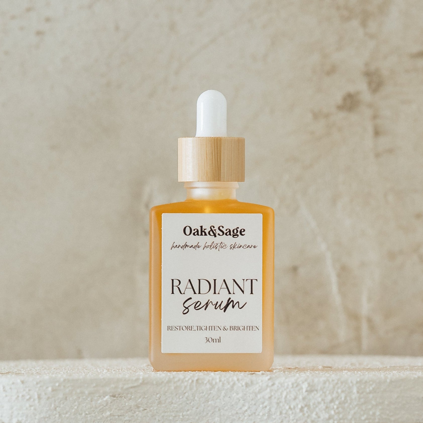 Oak & Sage Radiant Serum in frosted glass bottle with bamboo dropper, brightening and firming skincare for radiant complexion, 30ml.