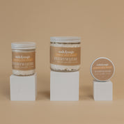 Oak & Sage Everywhere Cream in Warm Vanilla scent displayed in three sizes—large jar, medium jar, and travel tin—on minimalist white pedestals against a warm beige background