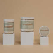Oak & Sage Everywhere Cream in Frankincense & Lavender  scent displayed in three sizes—large jar, medium jar, and travel tin—on minimalist white pedestals against a warm beige background