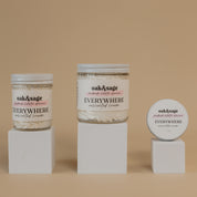 Oak & Sage Everywhere Cream in Unscented scent displayed in three sizes—large jar, medium jar, and travel tin—on minimalist white pedestals against a warm beige background